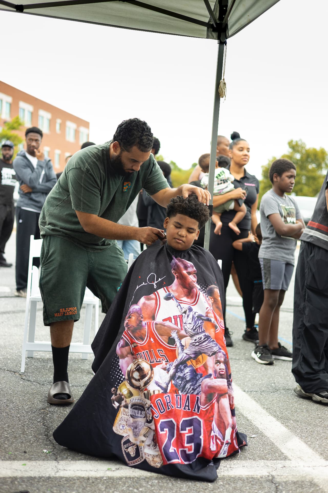 The barber tent stays packed all afternoon